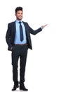 Full body picture of a happy business man presenting Royalty Free Stock Photo