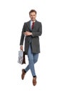 Happy young businessman with suitcase jumping in the air and laughing Royalty Free Stock Photo