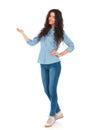 Full body picture of a smiling casual woman presenting Royalty Free Stock Photo