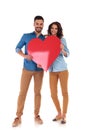 Young in love couple holding big red heart Royalty Free Stock Photo