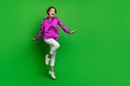 Full body portrait of astonished pretty lady jumping empty space offer proposition isolated on green color background