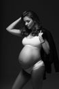 Pregnant female model in sports underwear standing and posing Royalty Free Stock Photo