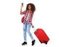 Full body attractive young african american girl walking with suitcase and taking selfie Royalty Free Stock Photo