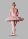 Full body portrait of ballerina dancer posing with grey background Royalty Free Stock Photo