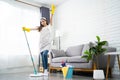 Full body portrait of a beautiful Asian woman cleaning and disinfecting all surfaces for safety reasons. She was holding a clean Royalty Free Stock Photo