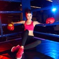 Full body portrait of boxer woman sitting in ring corner Royalty Free Stock Photo