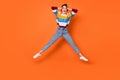 Full body portrait of cheerful person hands on head open mouth jump isolate don orange color background Royalty Free Stock Photo