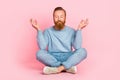 Full body portrait of content young man sitting floor closed eyes crossed legs meditate isolated on pink color Royalty Free Stock Photo