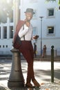 Full body cool african american fashion model with vintage suit posing with mobile phone in city Royalty Free Stock Photo