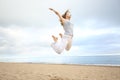 Excited happy woman jumping on the beach Royalty Free Stock Photo