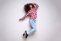 Full body excited young woman jumping in air against white background Royalty Free Stock Photo