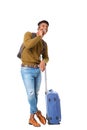 Full body handsome young african american man standing with luggage and talking with mobile phone against isolated white Royalty Free Stock Photo