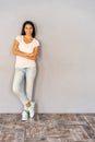 Full body portrait of happy smiling beautiful young woman, isolated over gray background. Royalty Free Stock Photo