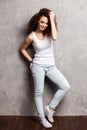 Full body portrait of happy smiling beautiful young woman, isolated over gray background. Royalty Free Stock Photo