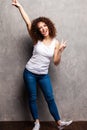 Full body portrait of happy smiling beautiful young woman, isolated over gray background. Royalty Free Stock Photo