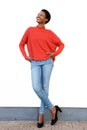 Full body happy young african american woman standing against white wall Royalty Free Stock Photo