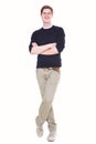 Full body happy young man standing on isolated white background with arms crossed Royalty Free Stock Photo