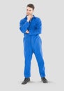 Full body portrait of mechanic Man standing with grey background Royalty Free Stock Photo