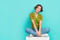 Full body portrait of nice young lady sit cube podium look empty space think isolated on turquoise color background Royalty Free Stock Photo