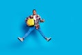 Full body portrait of nice young man suitcase jumping empty space wear shirt isolated on blue color background Royalty Free Stock Photo