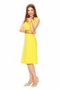 Full body portrait of smiling woman in yellow dress Royalty Free Stock Photo
