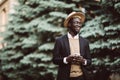 Full body portrait of young african business man walking outdoors with mobile phone in the street Royalty Free Stock Photo