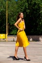 Full body portrait of a young beautiful woman in yellow dress Royalty Free Stock Photo