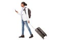 Full body portrait of young black woman walking with suitcase and mobile phone Royalty Free Stock Photo