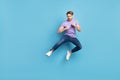 Full body portrait of young person look interested empty space fists ready to fight isolated on blue color background Royalty Free Stock Photo