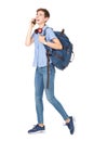 Full body young woman walking and talking with mobile phone and bag Royalty Free Stock Photo