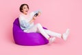 Full body profile photo of crazy attractive lady hands hold gamepad look empty space isolated on pink color background