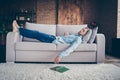 Full body profile photo of domestic handsome guy stay home quarantine time fall asleep reader book on floor lying