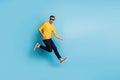 Full body profile photo of handsome man jumping hands playing imagine guitar isolated on blue color background Royalty Free Stock Photo