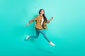 Full body profile photo of young active brunette lady run wear shirt jeans sneakers isolated on turquoise background