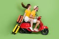 Full body profile portrait of two carefree crazy people drive moped fast speed on green color background