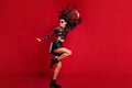 Full body profile side photo of charming lady dance fly hair raise hand isolated on red color background Royalty Free Stock Photo