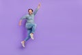 Full body profile side photo of cheerful mature man superhero jump isolated over purple color background