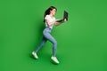 Full body profile side photo girl jump run search discount laptop wear t-shirt jeans isolated green bright color