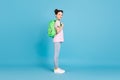 Full body profile side photo of happy little girl wear backpack student isolated on pastel blue color background Royalty Free Stock Photo