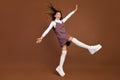 Full body profile side photo of young excited girl have fun wear platform casual outift isolated over brown color Royalty Free Stock Photo