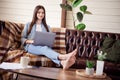 Full body profile side photo of young girl happy positive smile sit couch comfort work laptop self-isolation indoors Royalty Free Stock Photo