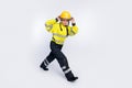 Full body profile side photo of young woman firefighter go run dangerous emergency isolated over white color background Royalty Free Stock Photo