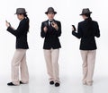 Full body 20s Asian Woman wear business suit tie dress pant hat glasses. Detective female hold magnifying phone confident Royalty Free Stock Photo