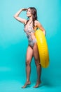 Full body Woman in swimsuit with yellow inflatable ring isolated over green background Royalty Free Stock Photo