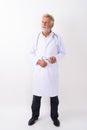 Full body shot of handsome senior bearded man doctor standing an Royalty Free Stock Photo