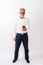 Full body shot of handsome senior bearded man standing mobile ph Royalty Free Stock Photo