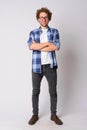 Full body shot of happy hipster man with eyeglasses smiling and crossing arms Royalty Free Stock Photo