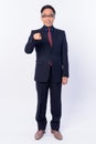 Full body shot of happy Japanese businessman in suit pointing at camera Royalty Free Stock Photo