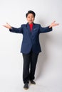 Full body shot of happy mature Asian businesswoman presenting something