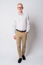 Full body shot of happy young blonde businessman with eyeglasses smiling Royalty Free Stock Photo